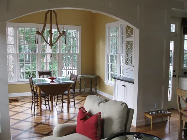 Open dining area connected to a remodeled kitchen with arched windows