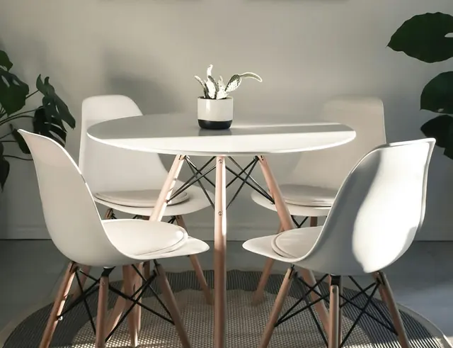 Simple dining table in a bright, freshly finished room